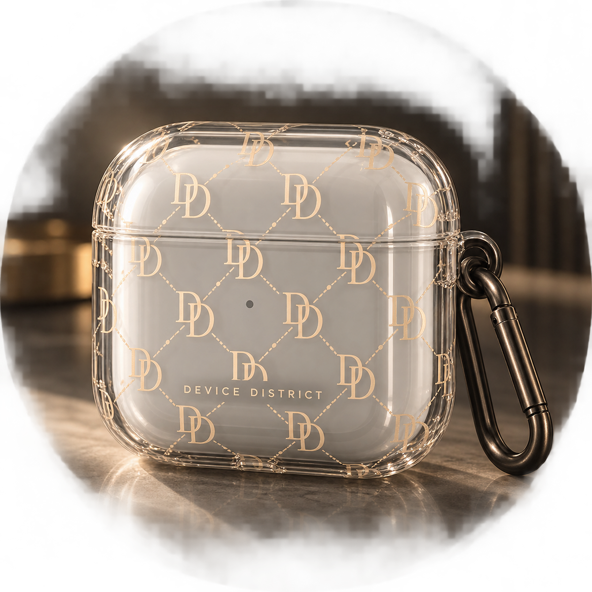 Clear Device District DD Monogram AirPods case with champagne gold pattern and dark carabiner